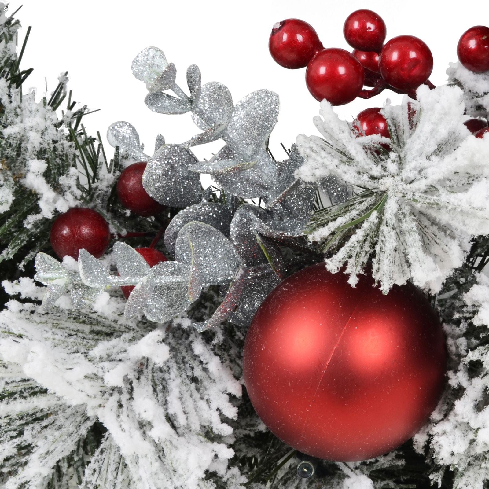 detail shot of christmas wreath with red baubles and silver foliage